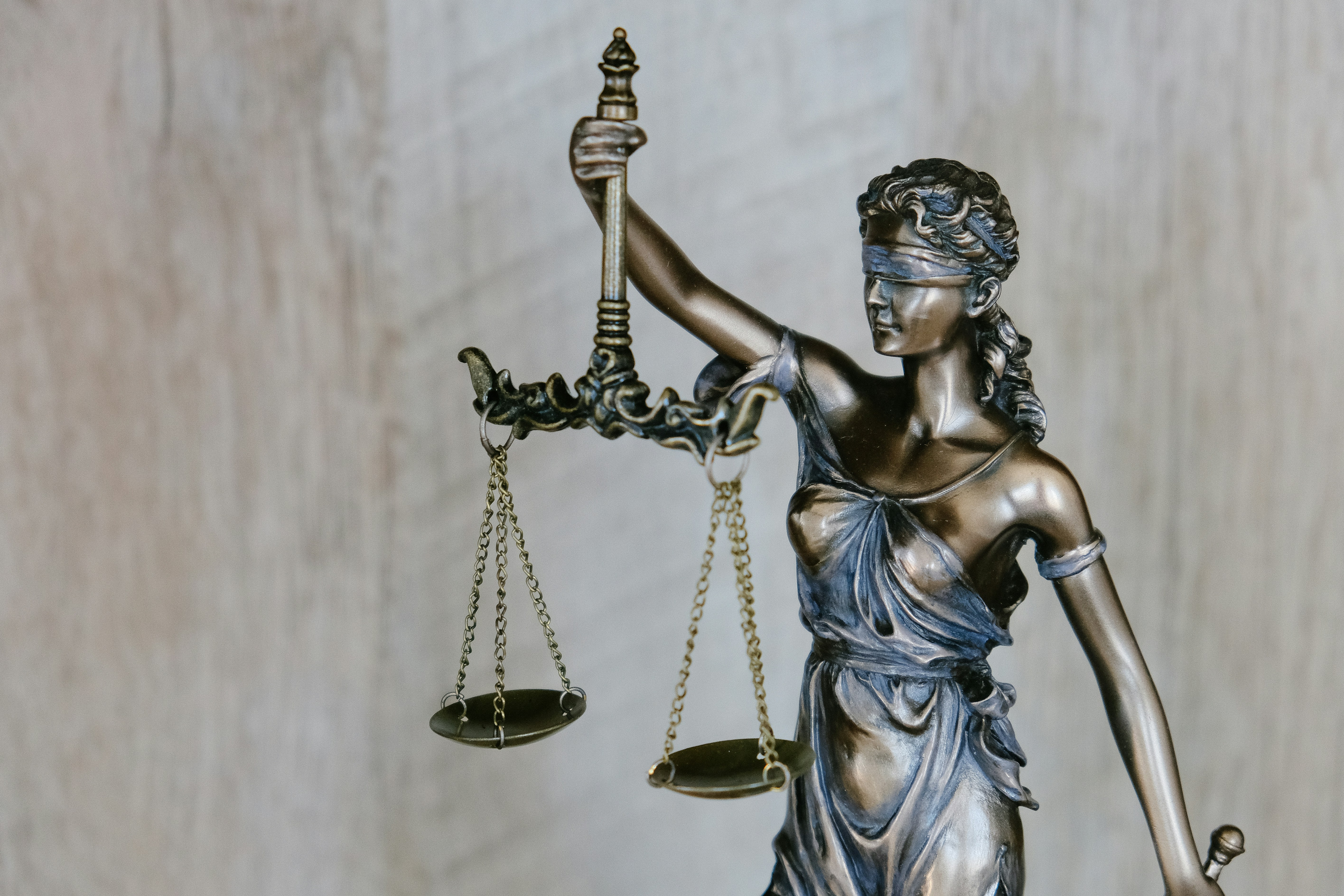 Bronze statue of Lady Justice holding scales
